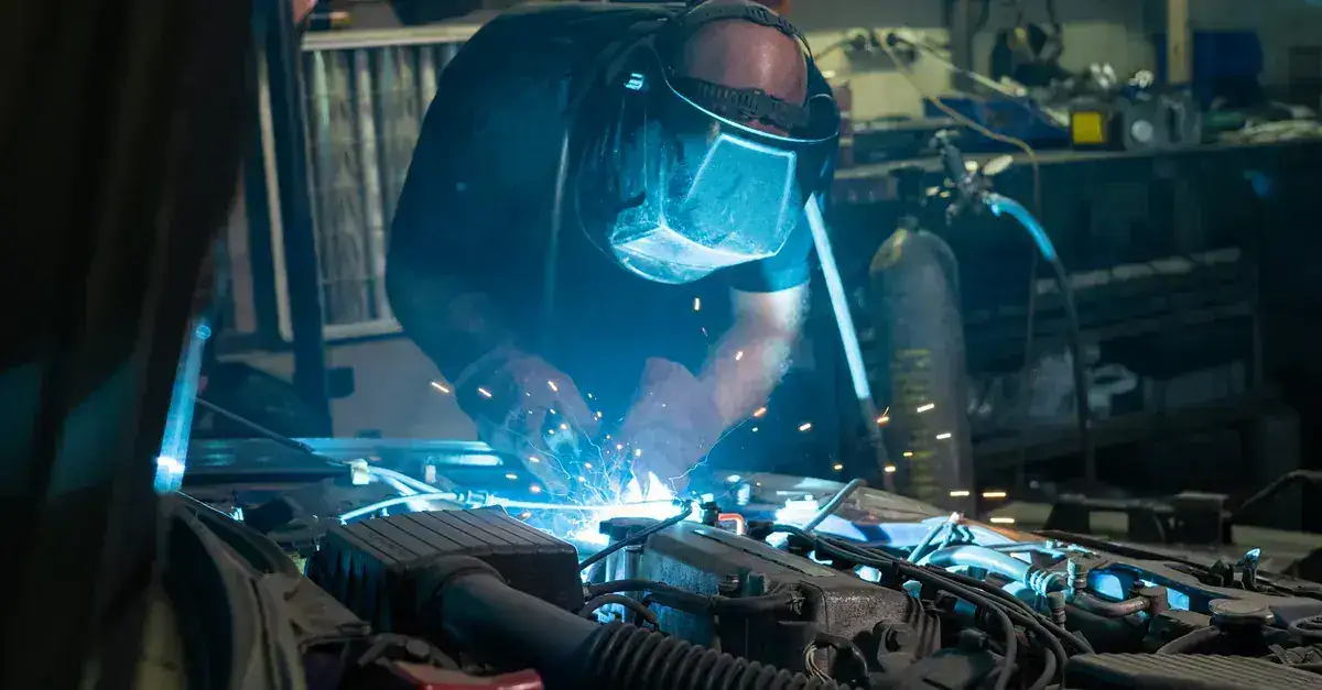 Bright blue welding arc during automotive fabrication